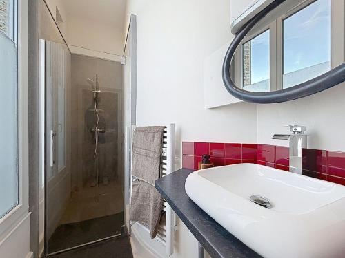 a bathroom with a sink and a shower and a mirror at Le Studio du Chateau in Bréviandes
