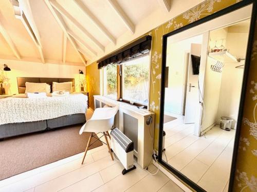 a bedroom with a bed and a desk and a window at Bed and breakfast private accommodation at Amsterdam Houseboat in Amsterdam