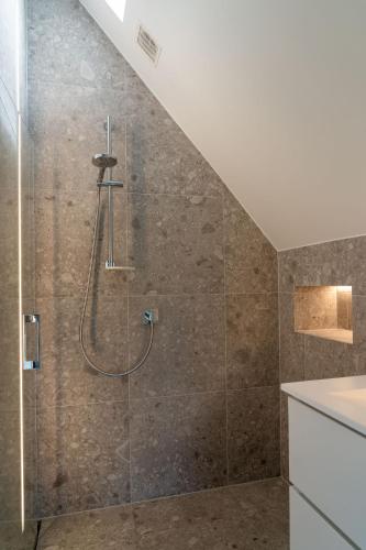 a bathroom with a shower with a glass door at Apartment L'O Reine, B&B in Sint-Pieters-Leeuw