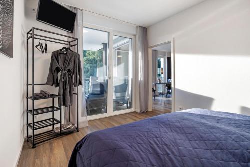 a bedroom with a bed and a sliding glass door at Egge Resort 7f mit Whirpool u Sauna in Altenbeken