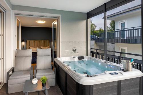 a jacuzzi tub in the middle of a balcony at Egge Resort 7f mit Whirpool u Sauna in Altenbeken