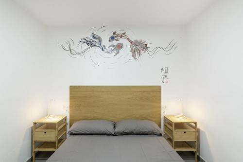 a bedroom with a bed with a painting on the wall at Casa Isabel eccezionale Vista Mare in Mogán