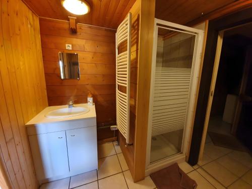 a small bathroom with a sink and a shower at Chalet Du Saix - Sauna in La Chapelle-dʼAbondance