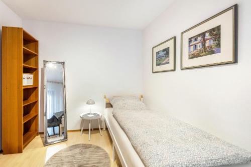 a bedroom with two beds and a mirror at Ferienwohnung an der Kriemhildmühle in Xanten