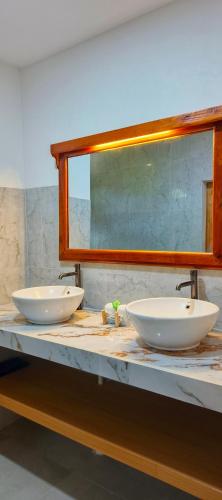 two white sinks on a counter in a bathroom at Yaya BCB in Gili Meno