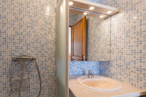 a bathroom with a sink and a shower at Les Sources Gîte La Remise in Chambonas