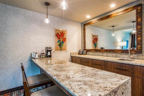 a bathroom with two sinks and a large mirror at Choctaw Casino & Resort Grant, Trademark Coll by Wyndham in Grant