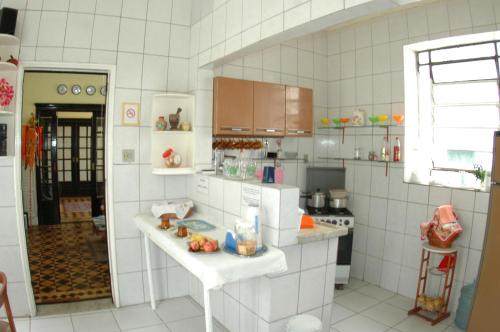 a white tiled kitchen with a white counter top at Reisnger Hostel in Rio de Janeiro