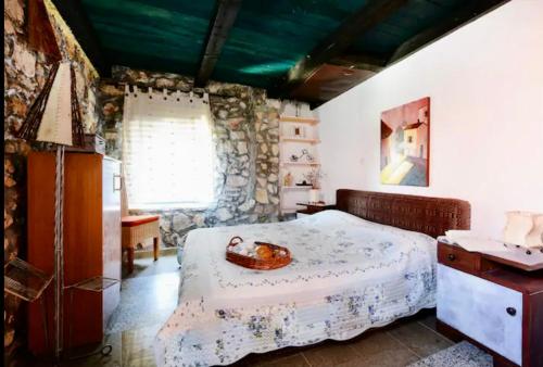 a bedroom with a bed with a bowl on it at Robinson House with Pool & Seaview in Ždrelac