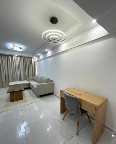 a living room with a couch and a table at Shangri-la residence Westlands-Remote working & gym in Nairobi