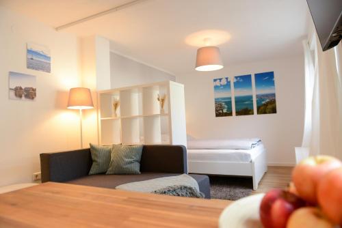 a living room with a couch and a bed at Ferienwohnung Malou in Tettnang