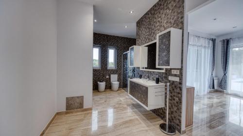 a bathroom with a sink and a mirror at Costacabana - Villa Madison in Lloret de Mar