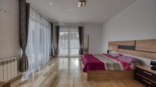 a bedroom with a bed and a large window at Costacabana - Villa Madison in Lloret de Mar