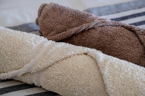 a teddy bear laying on top of a towel at StableWood Lodge in Kimberley