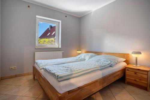 a bedroom with a bed and a window at Haus Janni in Freest