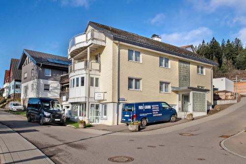 a blue van parked in front of a building at Ferienwohnungen Uhren Allgaier in Schönwald
