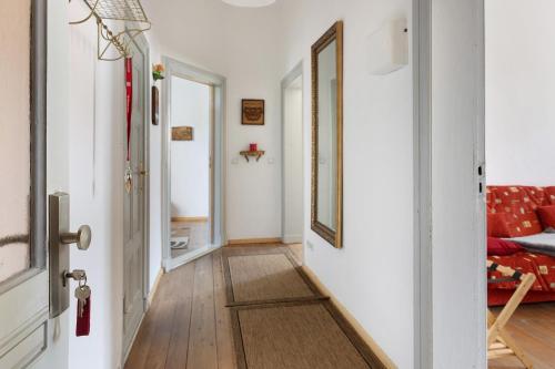 a hallway with white walls and a red couch at Kurfürstensuite in Brandenburg an der Havel