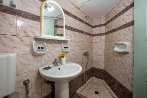a bathroom with a sink and a mirror at Sunrise Apartments Crete in Sfakaki