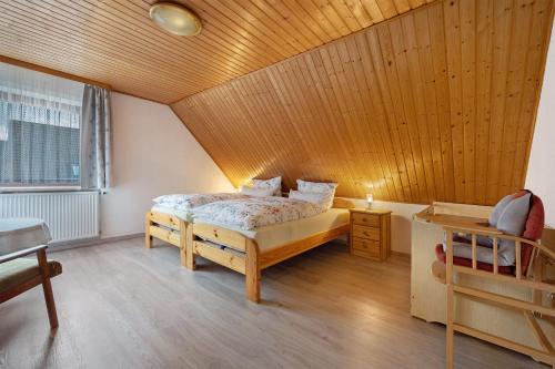 a bedroom with a bed and a wooden ceiling at Haus Stoldt in Meldorf