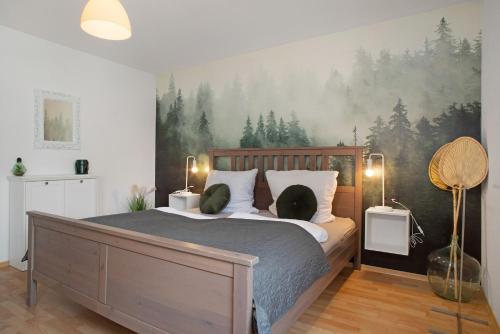 a bedroom with a bed with a painting on the wall at Geräumige schöne Ferienwohnung in Weingarten