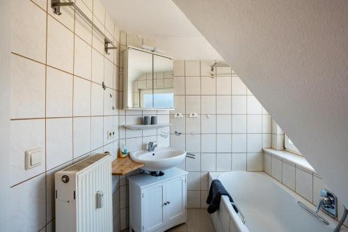a bathroom with a sink and a toilet and a tub at Schwarzwaldnest in Bad Wildbad