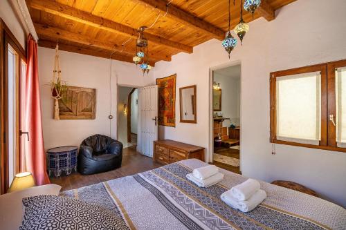 a bedroom with a bed and a living room at La lechuga azul in Güéjar-Sierra