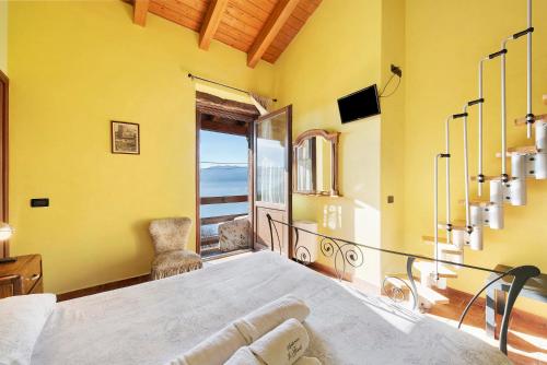 a bedroom with a large bed with a view of the ocean at Agriturismo El Giardì in Marone