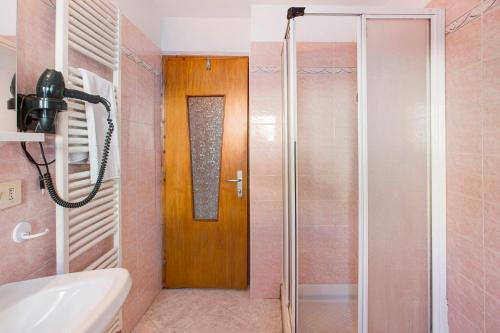 a bathroom with a shower and a glass door at Lovin Winter in Livigno