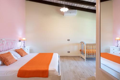 a bedroom with a bed and a crib in a room at Casa Sole in Dorgali