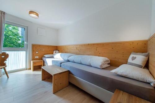 a room with three beds and a window at Gass Apartment A in Laion