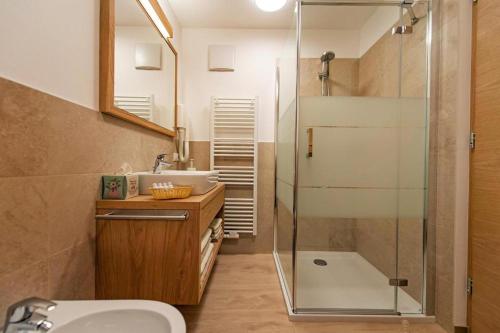 a bathroom with a glass shower and a sink at Gass Apartment A in Laion