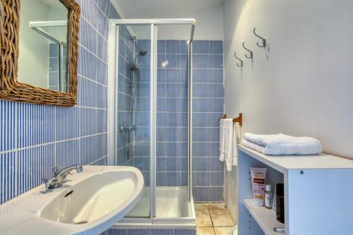 a bathroom with a sink and a shower at Mas des Cypres - Mazet 7 in Saintes-Maries-de-la-Mer