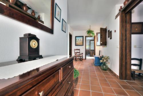 a room with a counter with a clock on it at Casa Jimena 2 personas in Jimena de la Frontera