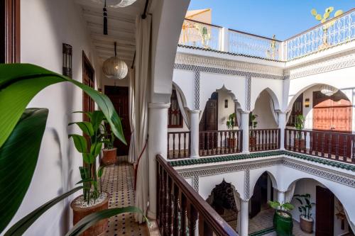 a hallway of a house with white walls and ceilings at Riad Lalla Azalay in Marrakesh