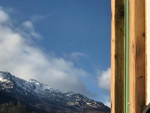 a view of a snow covered mountain from a window at Ferienwohnung Mountaintop in Lienz