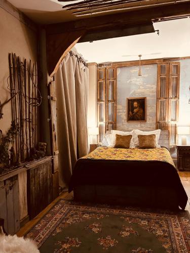 a bedroom with a large bed in a room at L Annexe d Aubrac in Aubrac