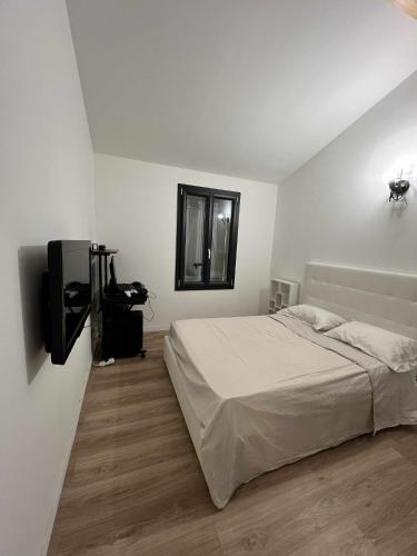 a bedroom with a bed and a flat screen tv at Cosy Home Stay in Mimet