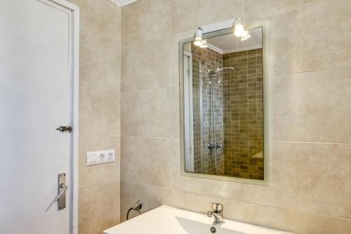 a bathroom with a sink and a mirror at Escala Riells in L'Escala