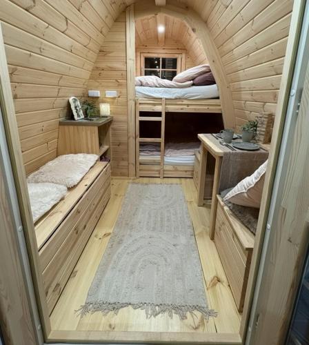 a small room with two beds in a wooden cabin at Adam Campingplatz in Bühl