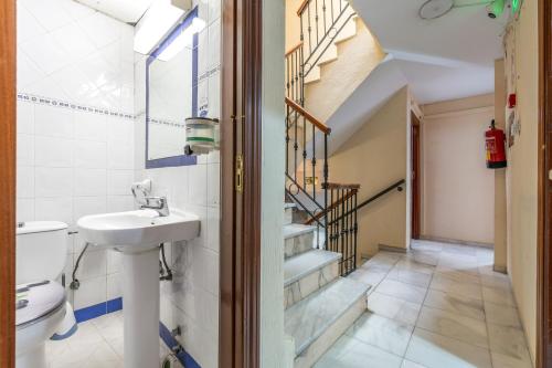 a bathroom with a sink and a toilet at Pensión Veracruz 1 in Granada