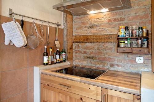 a kitchen with a sink and a brick wall at Fereienhaus Usedom Achterland in Dewichow