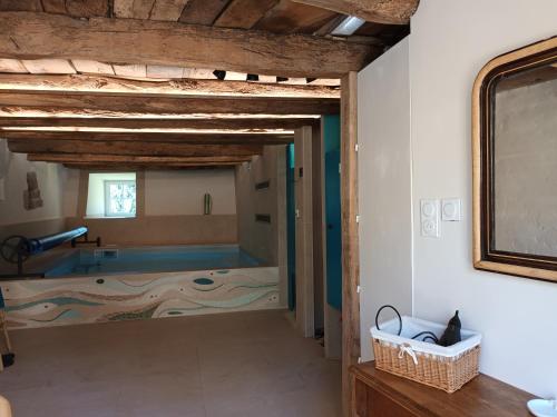 a view of a bathroom with a tub in a room at La Clé des Sens in Castelnau-Pégayrols