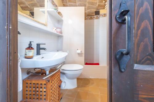 a bathroom with a white toilet and a sink at Can Tarana in Santa Cristina d'Aro