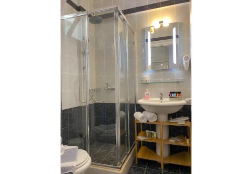 a bathroom with a shower and a sink at Sunset Premium Studio 13 in Lefkada