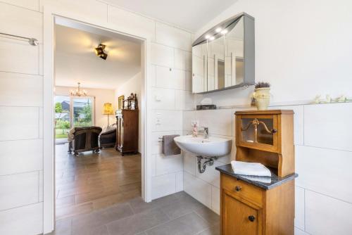 a bathroom with a sink and a mirror at Ferienwohnung "Haus Kellenburg" in Albstadt