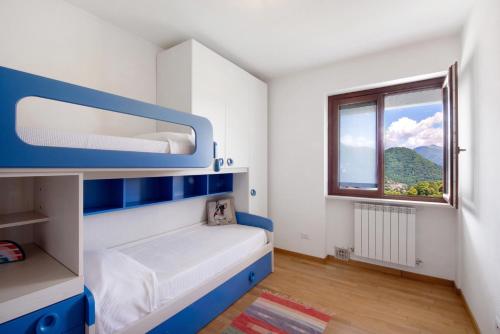 a small bedroom with a bunk bed and a window at Loft bellavista in San Fedele Superiore