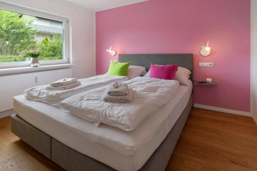 a bedroom with a large bed with towels on it at Traumblick in Bad Liebenzell