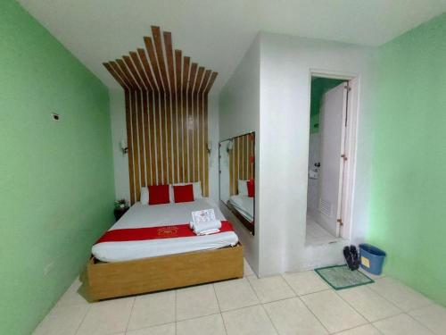 a bedroom with a bed in a green room at MCT Hotel in Manila