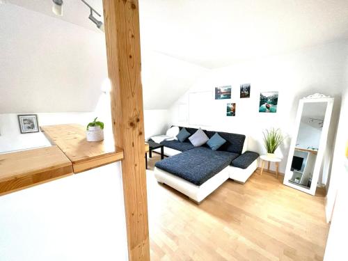 a living room with a couch and a table at Osserblick Galerie in Lohberg