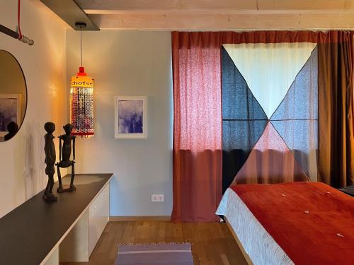 a bedroom with a bed and a curtain at Ferienwohnung Waldmeisterzimmer in Sankt Peter